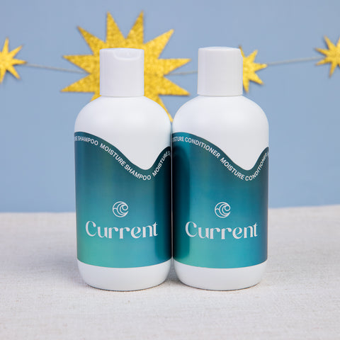 Current hair care shampoo and conditioner in white bottle with blue iridescent labels