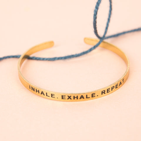 round metal bracelet with words inhale exhale repeat