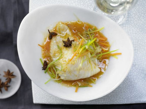 steamed turbot fish with vegetables in a bowl