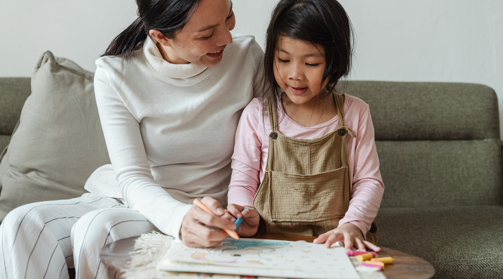 mom teaching her daughter how to color