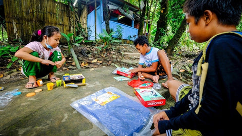 Children of Sitio Inigan play with the board games, action figures, and clays donated by Hasbro