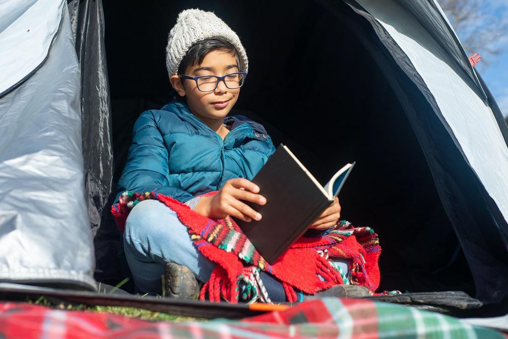 Boy camping in the backyard