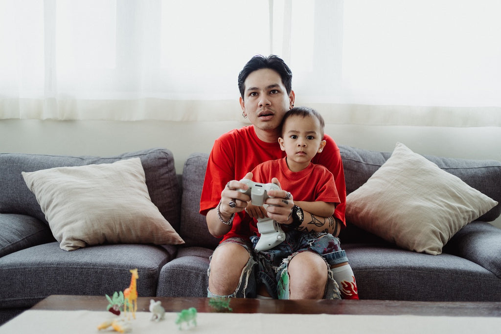 Dad playing video games with his son