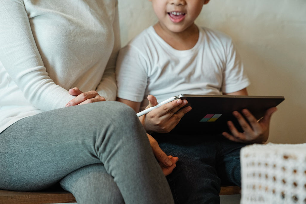 Mom playing with his son on iPad