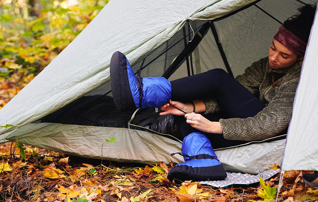 hiker putting on down booties