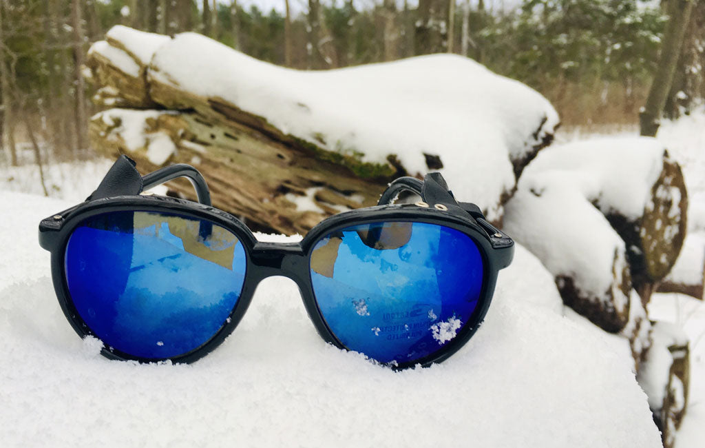 glacier glasses displayed in snow