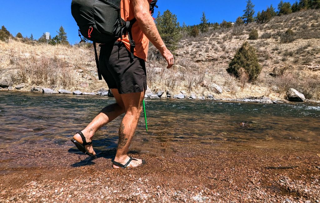 hiker wearing shamma mountain goats sandals on water