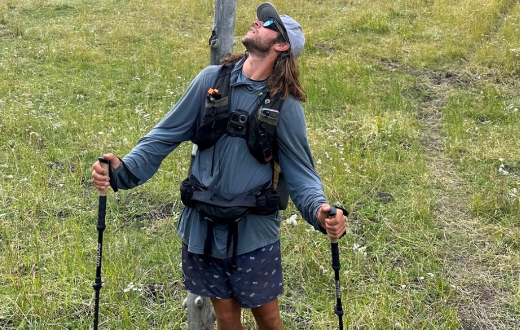 hiker with swift x and trekking poles