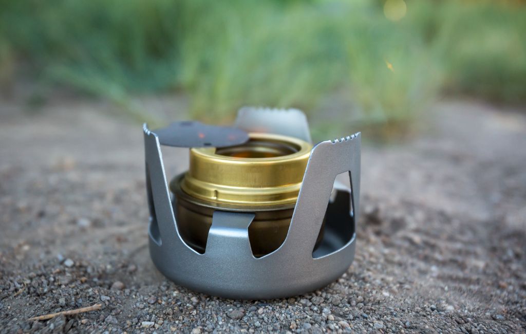 I use this wick alcohol stove. It is super light and allows me to