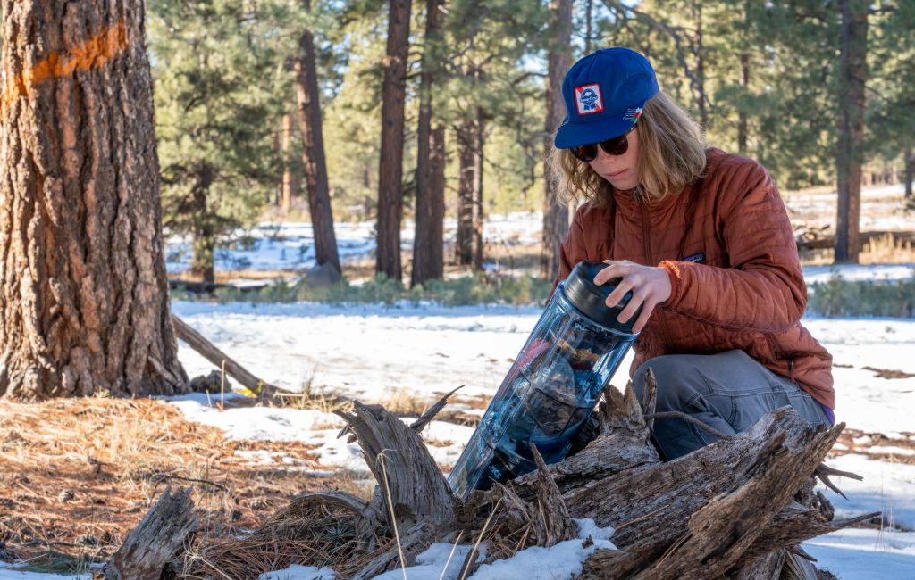 hiker opening bear canister