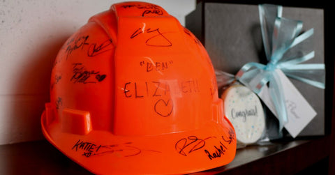 image of orange hard hat with signatures