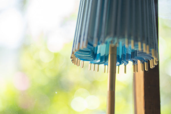 A figure with a Japanese umbrella propped up