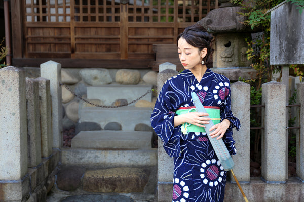 holding a Japanese umbrella