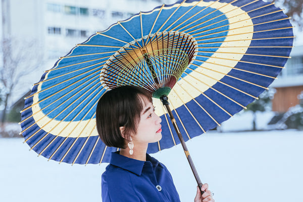 A woman holding an umbrella to neutralize the snow