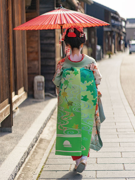 Maiko holding a Japanese umbrella and Kawaramachi, Gifu