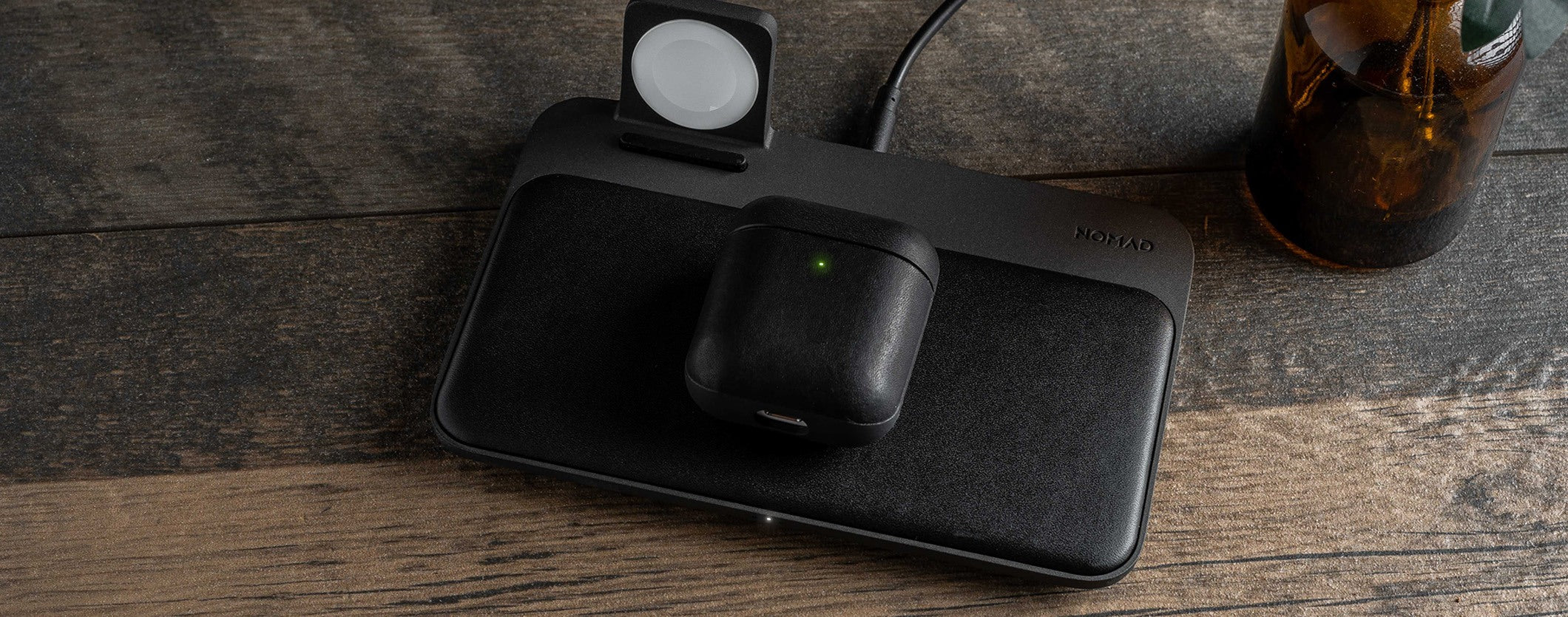 Closed Rugged Case in Black for Apple Airpods on a table