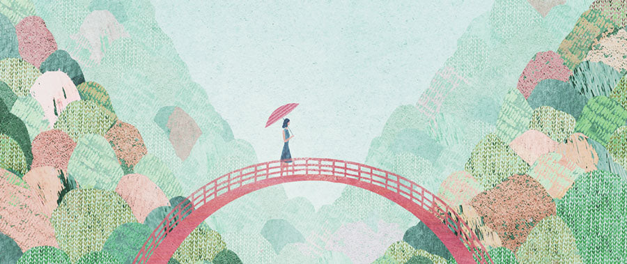 A woman walks over a bridge in Japan