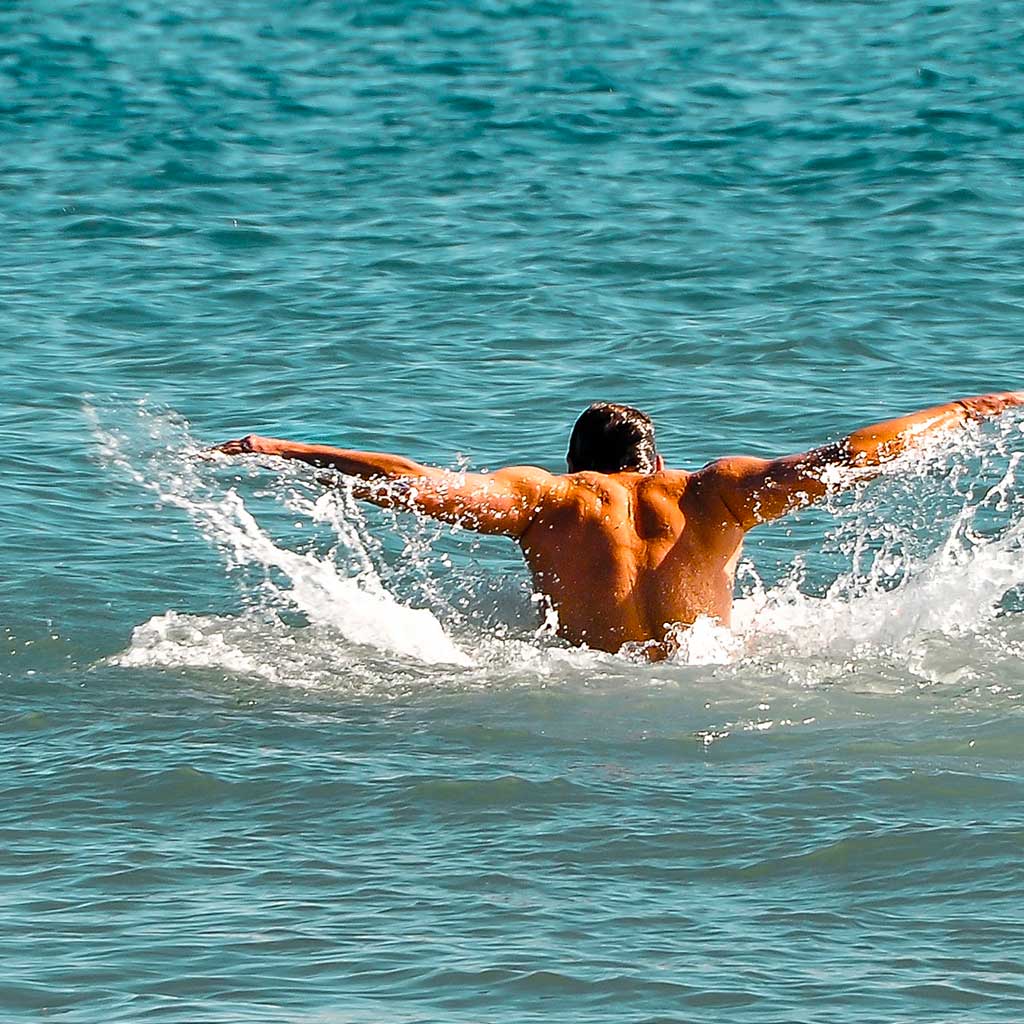 Man swimming in a lake.