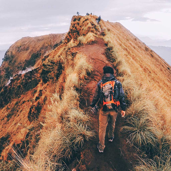 Man hiking in mountains during autumn.