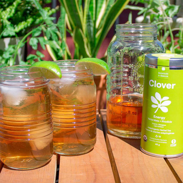 Clover's Energy tea blend on ice in 2 mason jars and a pitcher on a sunny balcony.