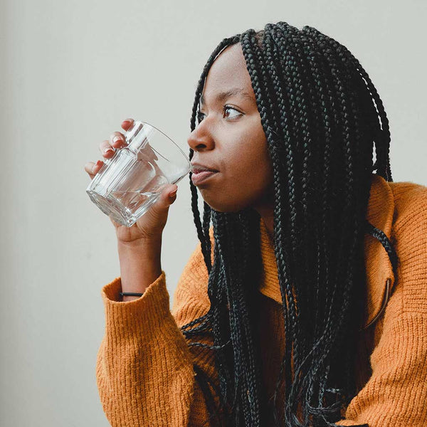 Woman drinking a glass of water.
