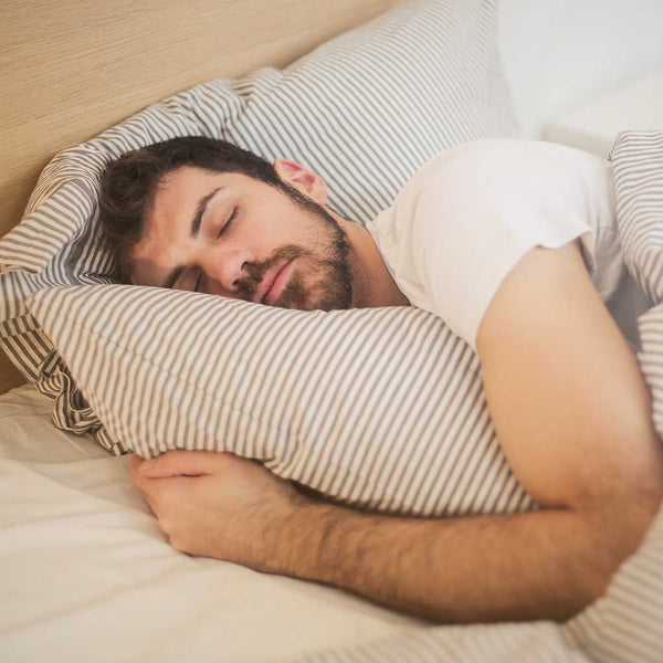 Man sleeping restfully in bed.