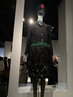 Prada (Italian, founded 1913) Miuccia Prada (Italian, born 1949) Ensemble, autumn/winter 2007-8 Coat of black silk-linen-synthetic gabardine novelty weave with green felted wool embroidered with black feathers and black rectangular sequins; skirt of black silk gabardine embroidered with black rectangular sequins