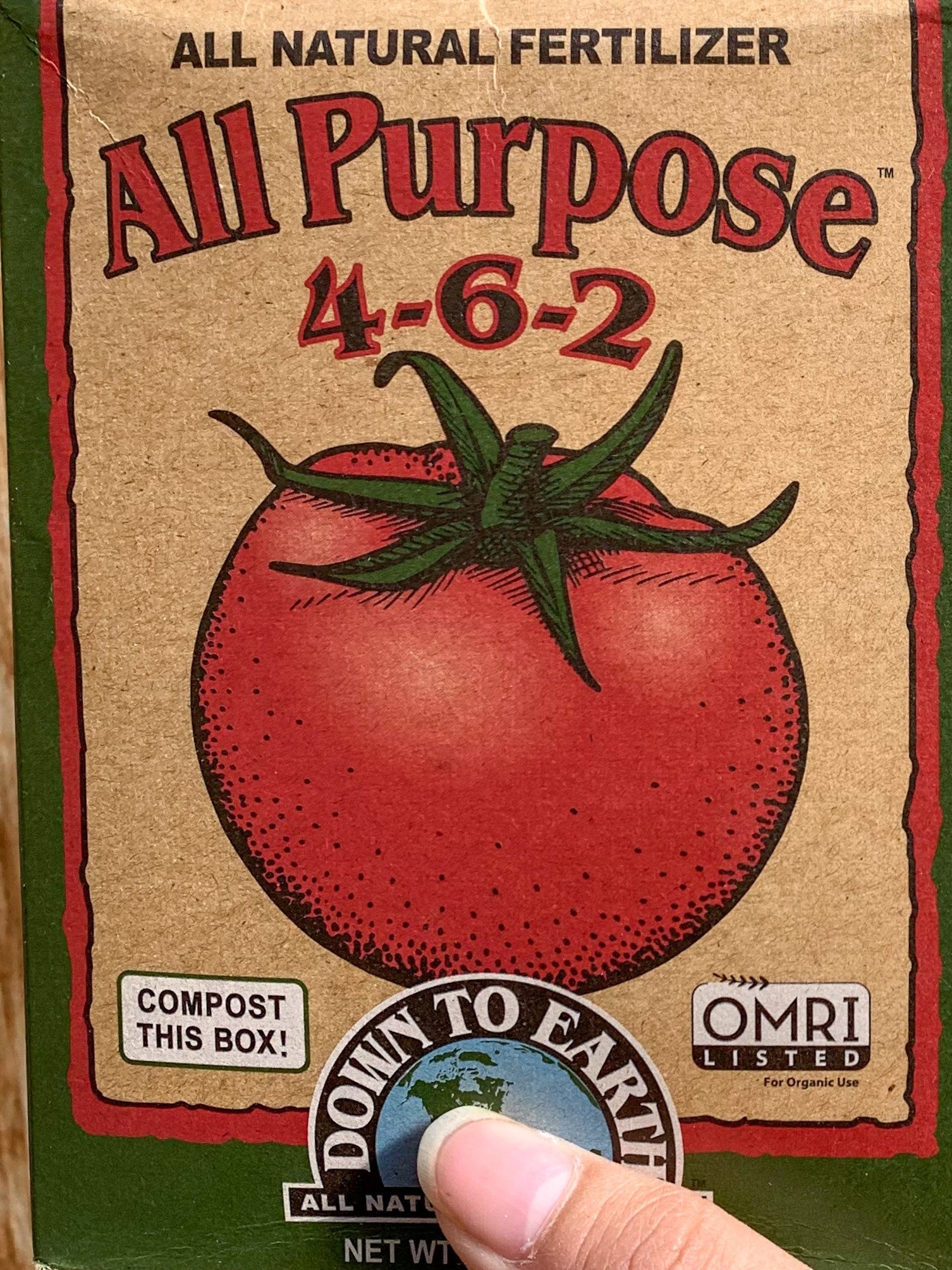 A box of "All Purpose 4-6-2" fertilizer. There is an image of a tomato on the front.