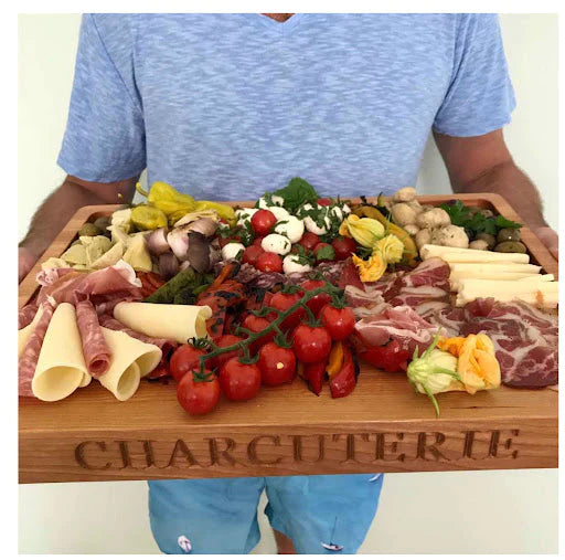 man holding a custom charcuterie board