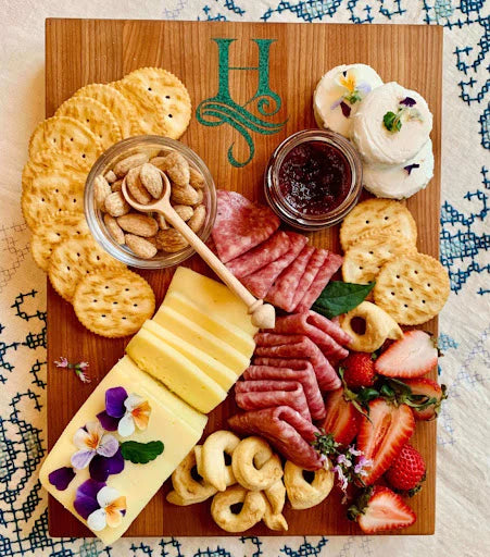 overhead: monogrammed charcuterie board with the letter H