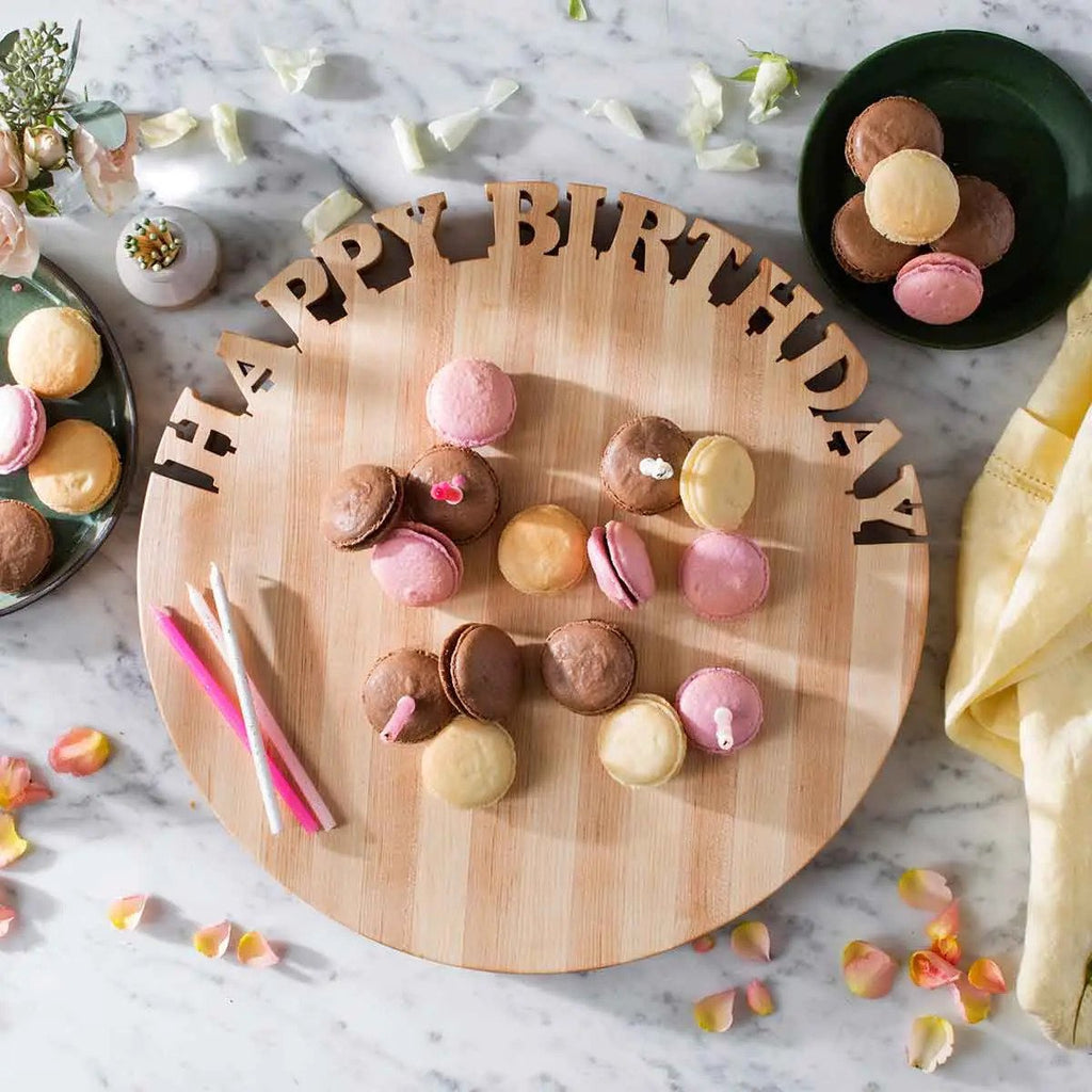 overhead: wooden carved happy birthday lazy Susan with macarons