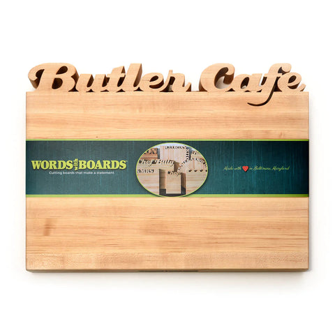 Maple Cutting Board with Script words Butler Cafe cut out on the top edge.