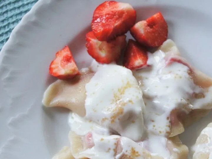 Fruit pierogis topped with whipped cream