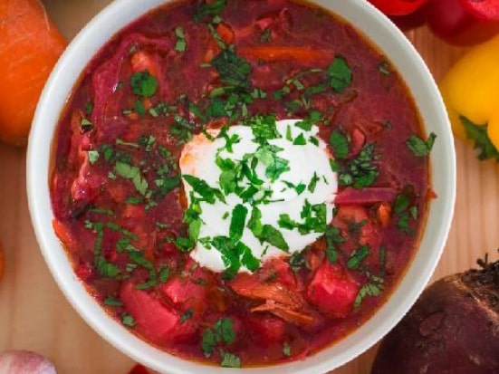 Cold red borscht soup with a dollop of sour cream