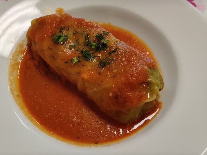 Stuffed cabbage topped with tomato sauce