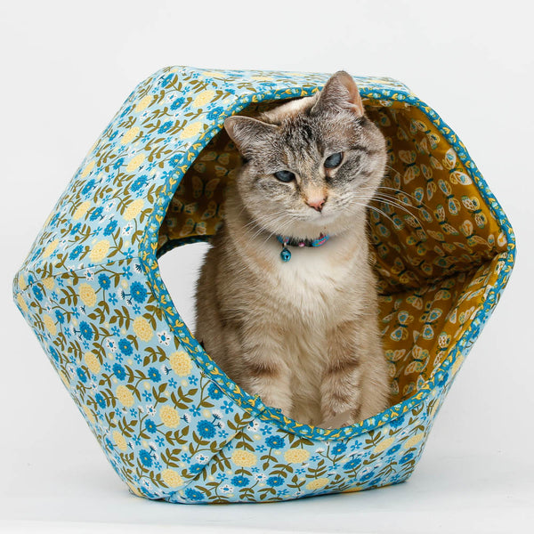 The Cat Ball cat bed made in blue flower print and lined with a coordinating yellow butterfly. 