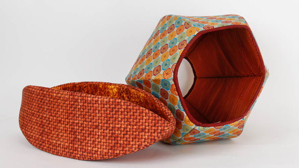 Cat Canoe® modern cat bed made in brown basket weave fabric and Cat Ball® in a metallic tile print 