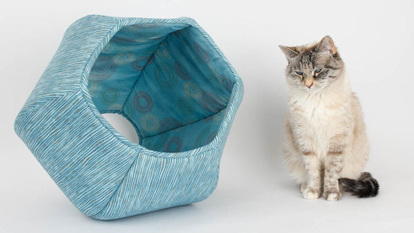 The Scandi Blue Stripes Cat Ball® cat bed is lined with a coordinating blue circle print. 