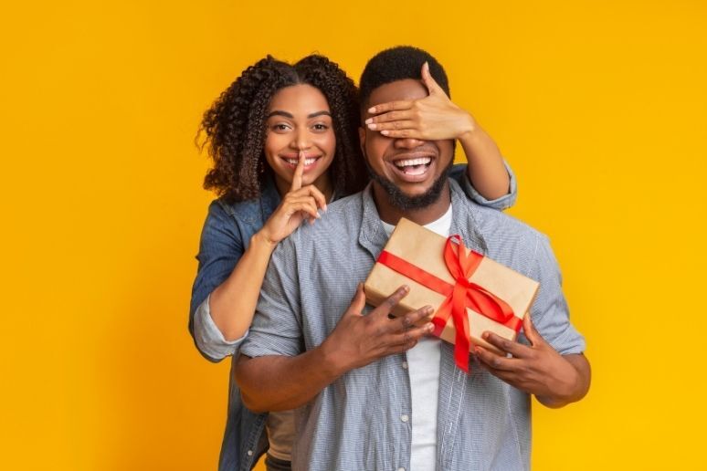 Woman surprising significant other with gift