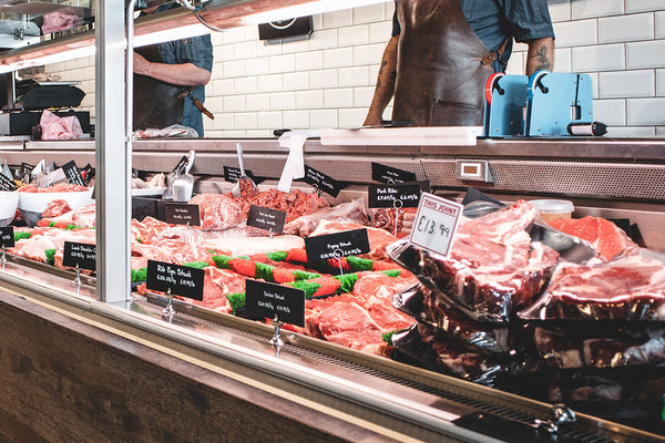 Butcher counter with beef cuts.