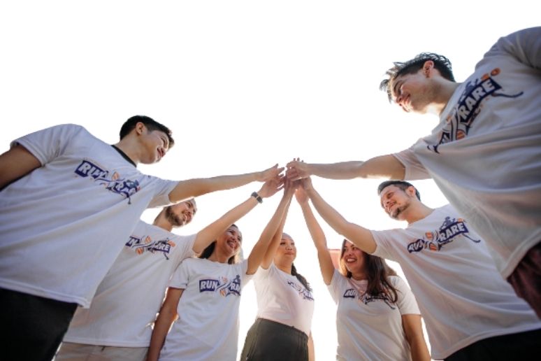 Group of people high fiving in a circle