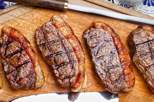 Cooked picanha steaks on a cutting board