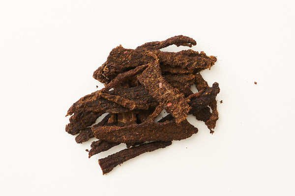 Hatch Green Chile Beef Jerky on white background.