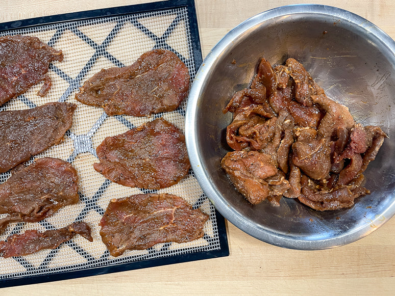 Laying the jerky on the dehydrator screens.