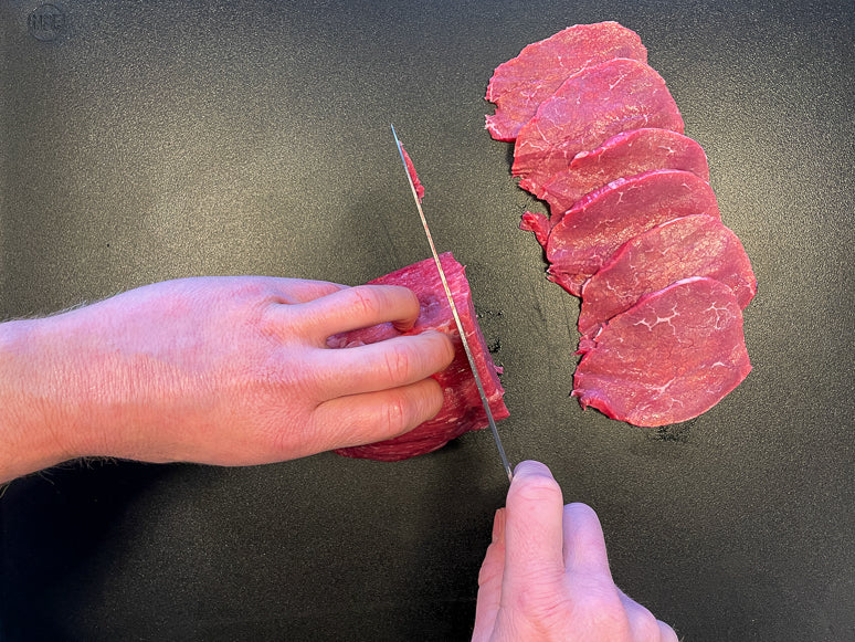 Slicing meat for homemade jerky.