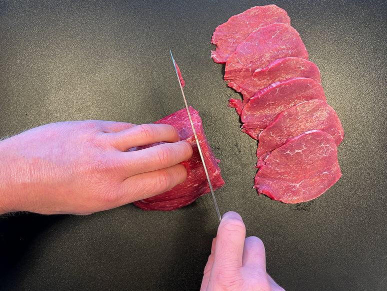 Slicing meat for beef jerky.