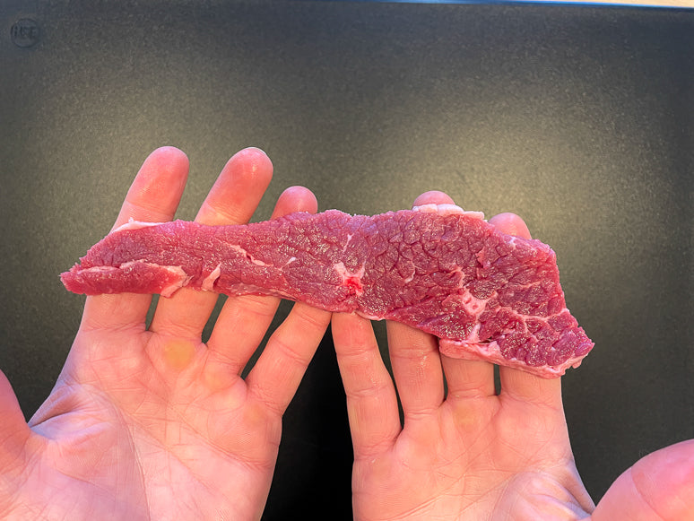 A piece of meat sliced against the grain.