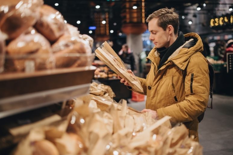 Someone holding bread in a bakery