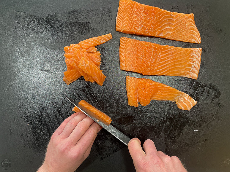 Slicing salmon into jerky slices.