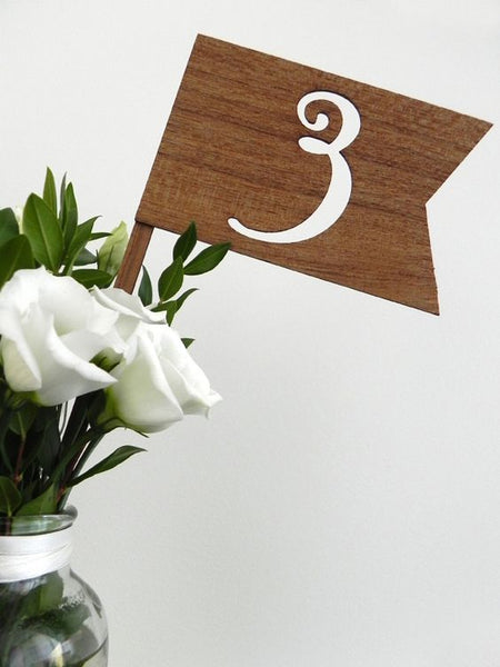 Print out a number, cut it out and put it on a block of wood for a rustic effect.